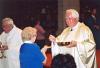 Archbishop MacNeil distributing Holy Communion