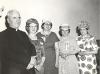 Msgr. Eugene Rooney standing with four women