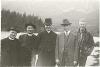 Group photograph of Archbishop O'Leary (center), Rev. McGuigan (first from left), two other priests, and one man (possibly a seminarian) with mountain view behind them.