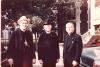 Archbishop MacDonald, Msgr. Carleton, and Rev. Joseph Burke standing outside, near a church