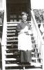 Archbishop MacDonald vested, standing on steps in Fort Chipewyan, NWT,  while there for a centennial celebration