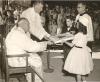 Archbishop MacDonald being presented with a card by a young girl and boy during his Silver Jubilee Celebrations