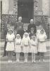 Archbishop MacDonald, Rev. Terence Wall, and confirmands standing in front of the church in Jasper