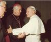 Pope John Paul II and Archbishop MacNeil speaking as they shake hands, in a line of bishops in Rome, Archbishop MacNeil present for his Ad Limina visit