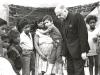 Archbishop Jordan standing with a mother and group of children