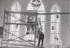 A man cleaning the stained glass windows in Immaculate Conception Parish, Edmonton