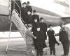 Archbishop MacDonald and seven other clergy disembarking from an airplane